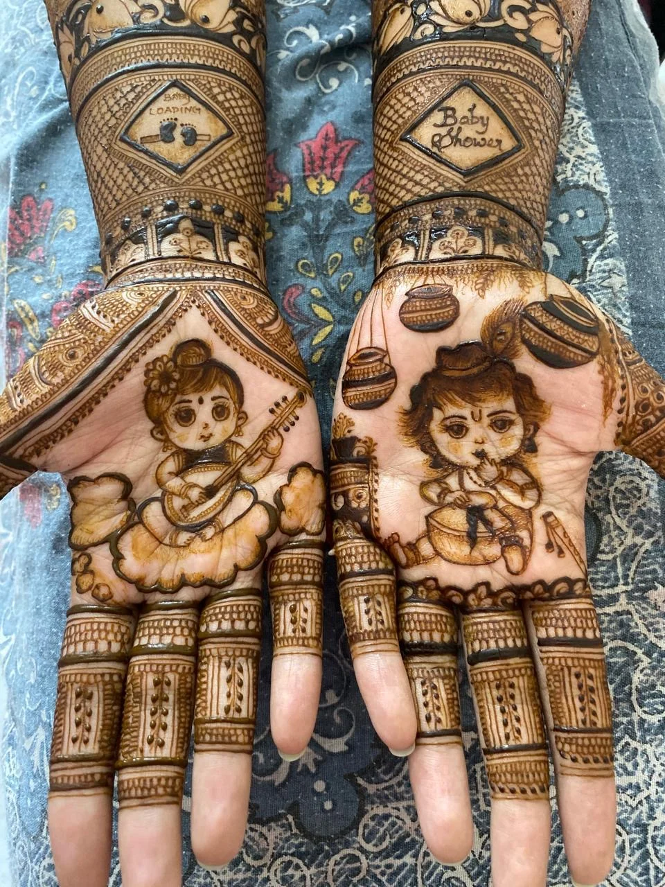 Beautiful baby shower mehndi design with baby motifs and floral patterns on hands